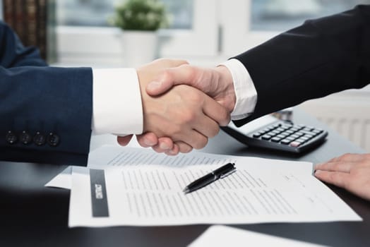 Business contract, agreement was signed by two business man shaking hands to each other