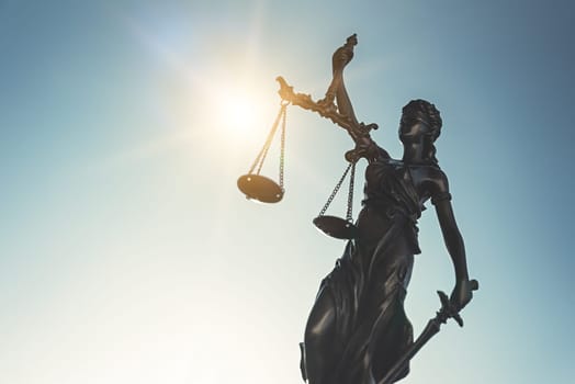 The Statue of Justice - lady justice, Themis, Justitia on sky background. Justice system concept