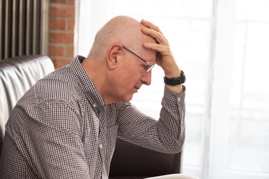 Older man has a headache. Senior healthcare concept