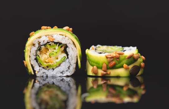 Sushi roll set on black glass background. Japanese Asian traditional food front view