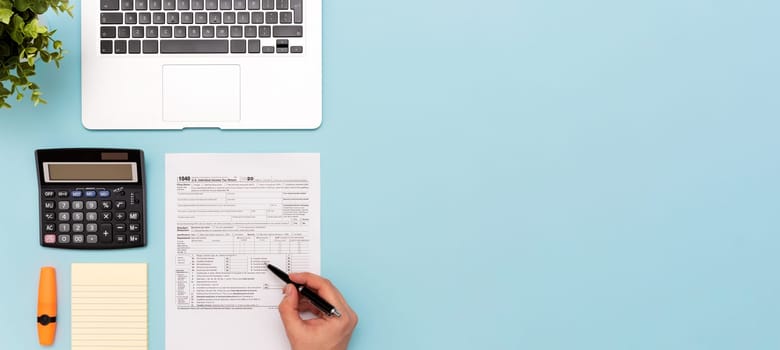 Tax income concept with US tax form. Documents on desk, top view 