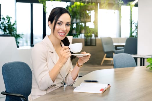 Businesswoman working in the office. Modern office interior in the background