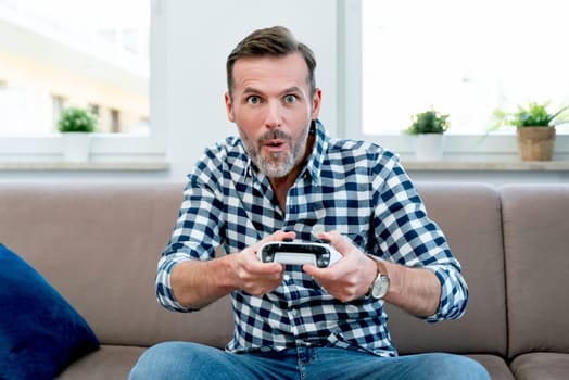 Man playing computer games, playing the console, holding pads in hands the. Joy of playing computer games