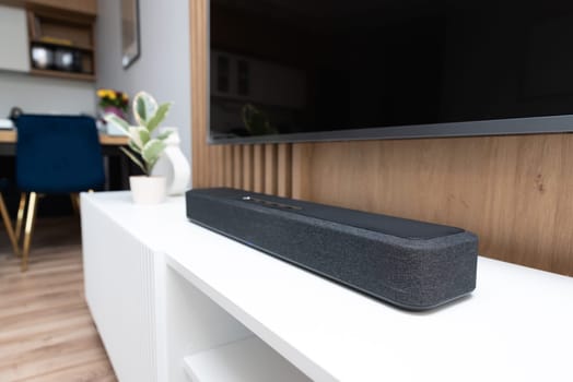 Soundbar in a modern home. Listening to music and watching movies