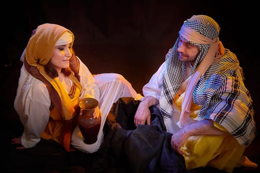 A couple in love or a married couple in stylized Eastern clothing from Israel, Palestine, Iran, Pakistan together. Tender photo session in the style of the Middle East and the Bible