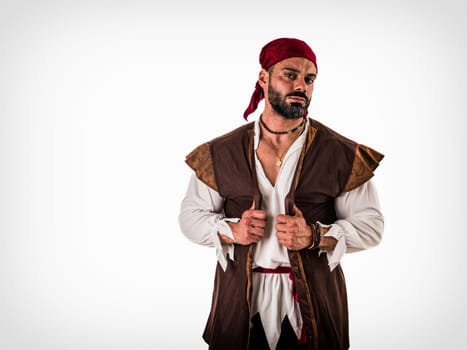 A muscular topless man with a red bandanna and pirate costume, standing isolated in front of a white background. A Brave Soul in Crimson: A Male Bodybuilder with a Red Bandanna Standing Proudly Before a Clean Canvas
