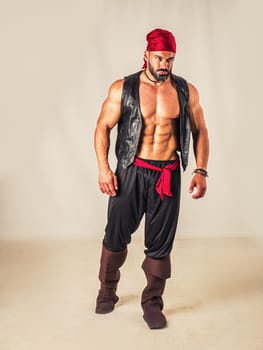 A muscular topless man with a red bandanna and pirate costume, standing in front of a white background