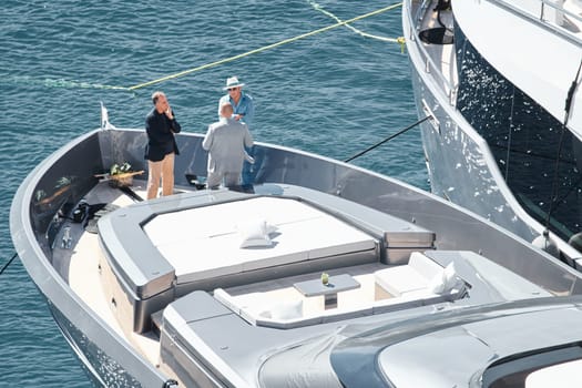 Monaco, Monte Carlo, 27 September 2022 - Invited wealthy clients inspect megayachts at the largest fair exhibition in the world yacht show MYS, port Hercules, yacht brokers, sunny weather. High quality photo