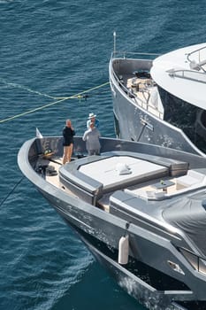 Monaco, Monte Carlo, 27 September 2022 - Invited wealthy clients inspect megayachts at the largest fair exhibition in the world yacht show MYS, port Hercules, yacht brokers, sunny weather. High quality photo