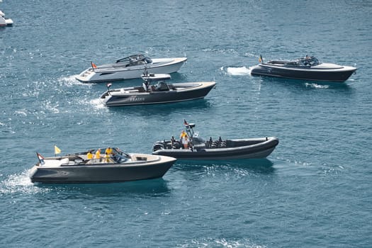 Monaco, Monte Carlo, 27 September 2022 - a boat with guests of yacht brokers departs from the shore in the largest fair exhibition in the world yacht show MYS, port Hercules, rich clients, sunny. High quality photo