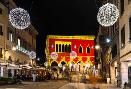 Udine, Italy, December 2023. the Christmas light decorations projected on the buildings of the historic center of the city
