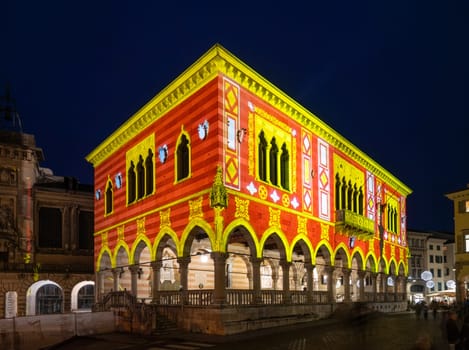 Udine, Italy, December 2023. the Christmas light decorations projected on the buildings of the historic center of the city