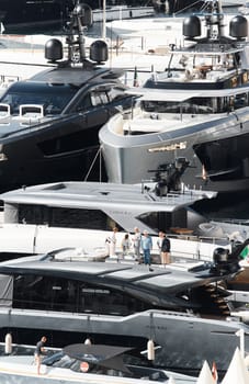 Monaco, Monte Carlo, 27 September 2022 - Invited wealthy clients inspect megayachts at the largest fair exhibition in the world yacht show MYS, port Hercules, yacht brokers, sunny weather. High quality photo