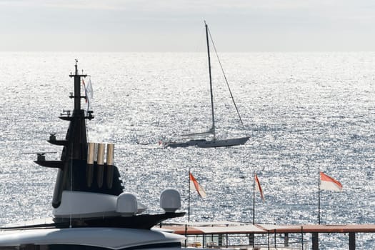 Monaco, Monte Carlo, 27 September 2022 - top of huge luxury yacht at sunny day, sailing yacht on background, the famous motorboat exhibition in the principality. High quality photo