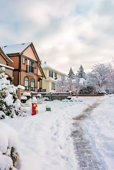 Cleared pathway along the row of residential houses on winter season in Vancouver, Canada