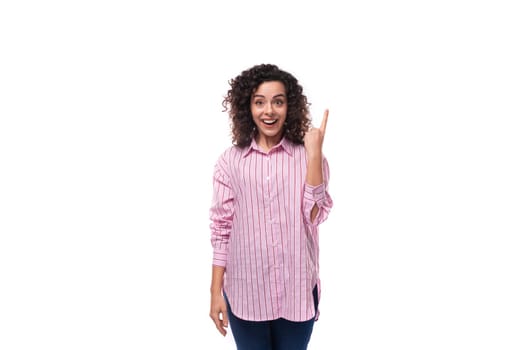 portrait of a young authentic caucasian woman with curly hair style dressed in a loose-fitting striped shirt.