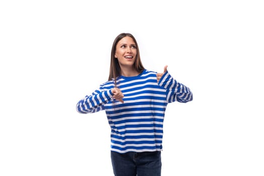 pretty young slender european model woman dressed in a blue sweater gesticulates actively. the concept of emotions and facial expressions.