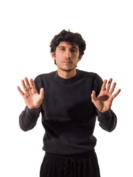 A man in a black sweater is holding his hands up, isolated on white background in studio shot