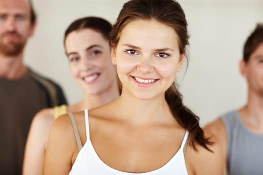 Portrait, smile or yoga and woman with a group of people in a studio for health, wellness or mindfulness. Fitness, exercise or pilates with happy young friends in gym class for holistic training.