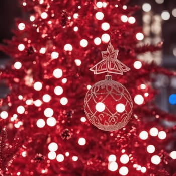 Close-UP of Christmas Tree, Red and Golden Ornaments against a Defocused Lights Background