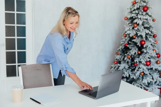 Business Woman Working On Laptop At Christmas Tree