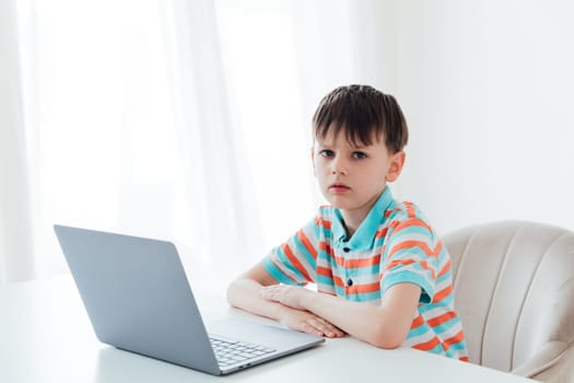 Boy working studying on laptop online