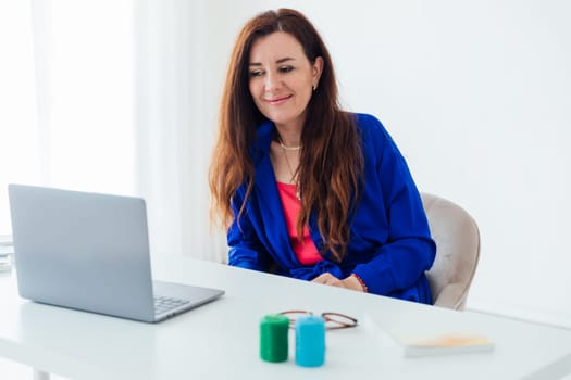 Business woman in office working on laptop online small business