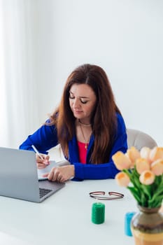woman in working on laptop online small business