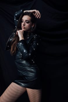 Portrait of a beautiful woman in a black leather dress
