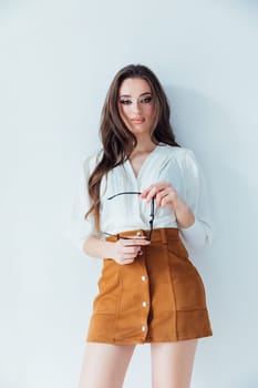 Beautiful fashionable woman in blouse and yellow skirt on white background