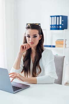 Business woman working on laptop in office finance business online