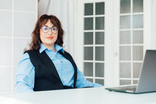 woman working on laptop in office online