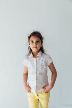 Portrait of a beautiful little girl of 8 years old on a white background