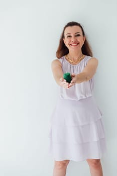 woman holding a green candle in her hands