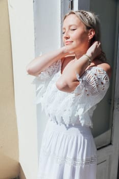 Portrait of a beautiful woman in a white summer dress