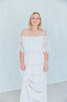 Portrait of a beautiful woman in a white summer dress