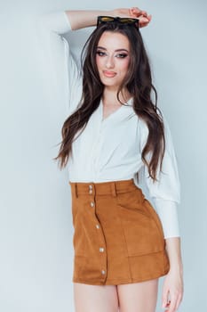 Beautiful fashionable woman in blouse and yellow skirt on white background