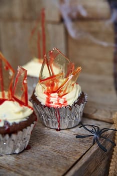 Spooky Halloween cupcakes with shattered sugar glass, blood-red drizzle, and a creepy black spider. Perfect for festive celebrations and themed events. Fort Wayne, Indiana.
