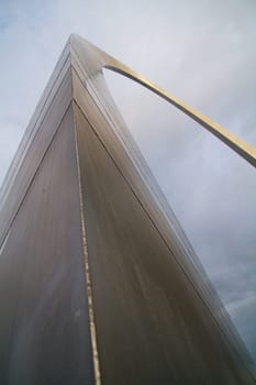 Iconic St. Louis Arch: Captivating modern architecture rises above the clouds, showcasing sleek stainless steel and clean lines. A symbol of innovation and urban development in Missouri.