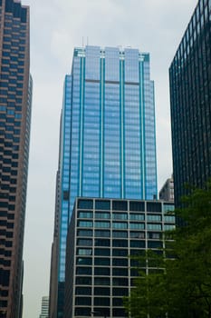 Dynamic Chicago skyline featuring iconic glass skyscraper amidst bustling cityscape, showcasing modern architecture and urban development in the vibrant financial district.