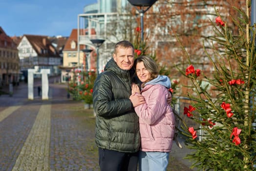 Romantic Christmas Stroll: Couple Embracing in the Charming Streets of Bietigheim-Bissingen, Germany