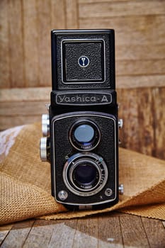 Vintage Yashica-A TLR Camera on a rustic burlap backdrop. Nostalgic charm meets intricate mechanics of this classic film camera.