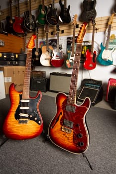 Vibrant guitar shop interior showcasing electric and semi-hollow models against a backdrop of assorted instruments. A haven for musicians and enthusiasts, capturing the creativity and joy of music-making in a welcoming retail space.