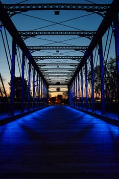 Captivating twilight view of the Wells Street Bridge, Fort Wayne, Indiana. The truss bridge architectural beauty and tranquil ambiance create a perfect symbol of connection and transition.