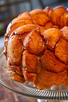 Delicious Monkey Bread with Caramelized Glaze on Glass Stand - Tempting homemade treat with soft, pull-apart texture and golden-brown color. Perfect for food enthusiasts, bakers, and sweet tooth cravings