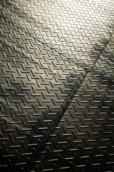 Industrial Durability: Close-up view of a textured metal surface with a diamond plate pattern, showcasing the rugged, non-slip texture for industrial settings and decorative features. Fort Wayne, Indiana.