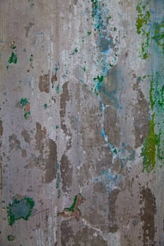 Captivating textures of urban decay captured in an abandoned Pierceton factory. Witness the weathered beauty of a worn concrete wall adorned with peeling paint in muted hues of green and blue.