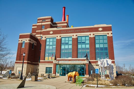 Stately red-brick building housing Science Central, adorned with oversized animal sculptures, evoking a sense of educational wonder and civic pride.