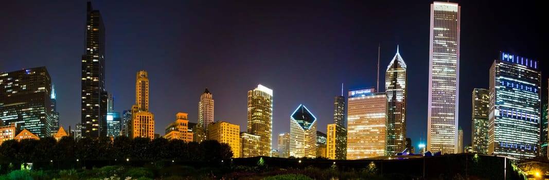Vibrant Nighttime Cityscape in Chicago, Illinois: A Glowing Panorama of Modern Architecture and Commercial Buildings Illuminating the Urban Skyline