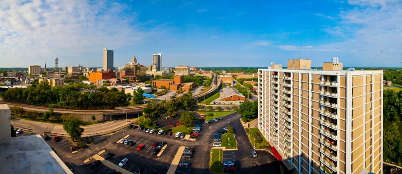 Dynamic urban growth and connectivity: A panoramic view of Fort Wayne, Indiana's skyline, blending modern high-rises with traditional architecture. From corporate hubs to sustainable living, this bustling cityscape captures the essence of business.